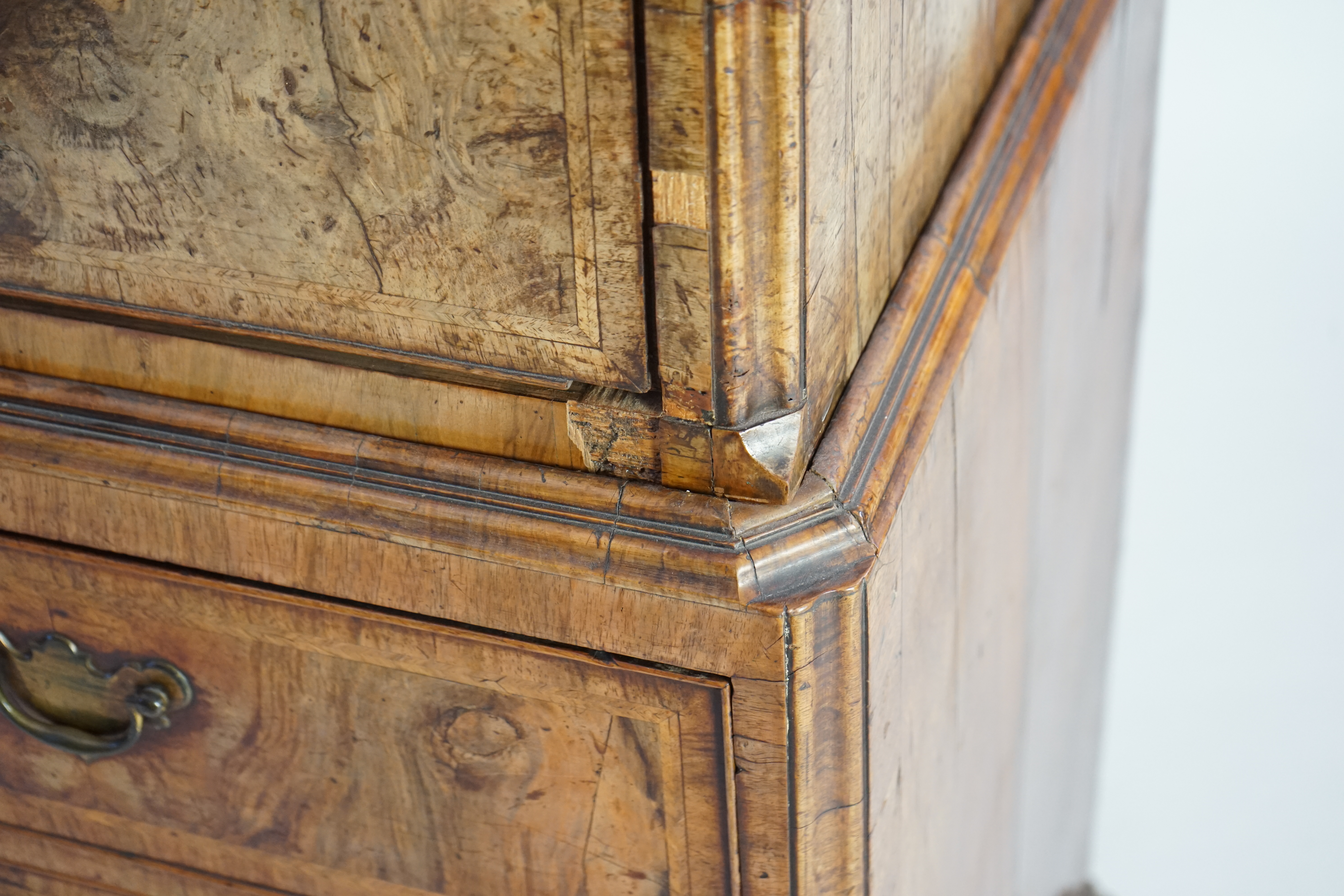 A George II feather banded walnut chest on chest